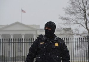 A member of the Secret Service Uniform Division stands guard in front of the White House under snowfall on January 21, 2014 in Washington, DC. The US government shut itself down Tuesday as a major snowstorm bearing down on the northeastern United States threatened to dump as much as 10 inches (25 centimeters) on Washington by day's end.AFP PHOTO/Mandel NGANMANDEL NGAN/AFP/Getty Images ORG XMIT: 464555285